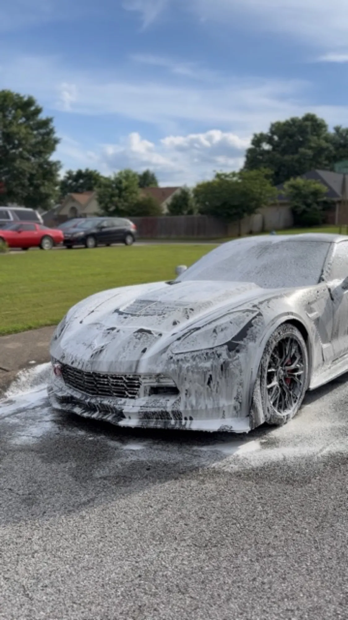 A Corvette covered in detailing snow-foam